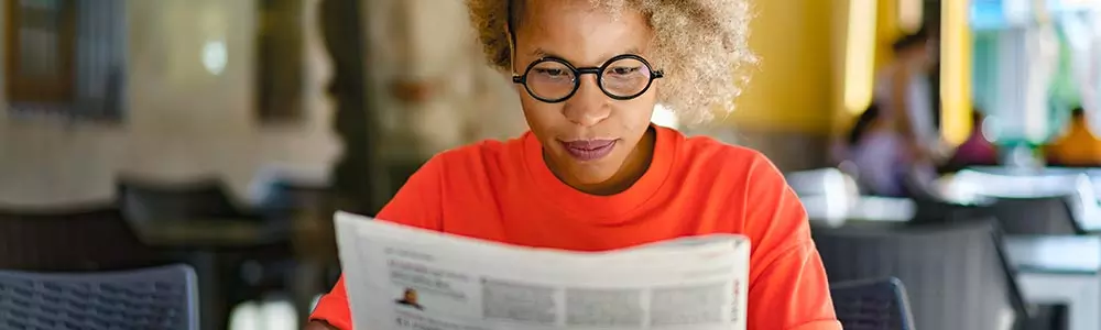 woman reading a newspaper