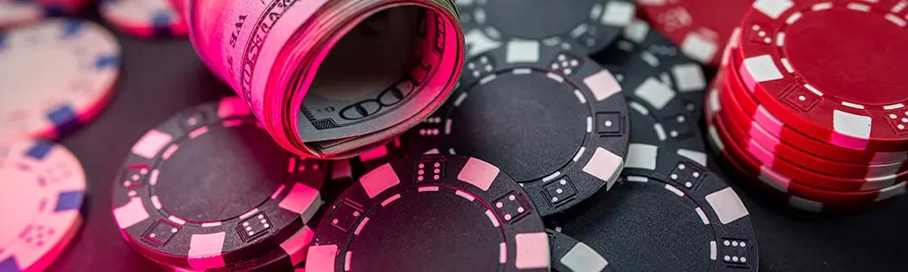 casino chips and roll of American dollars
