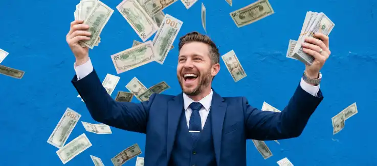 man in a suit holding high value dollar bills