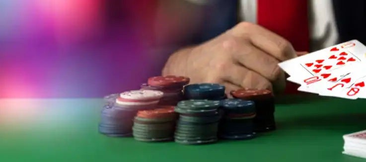 card player sitting at a poker table with chips
